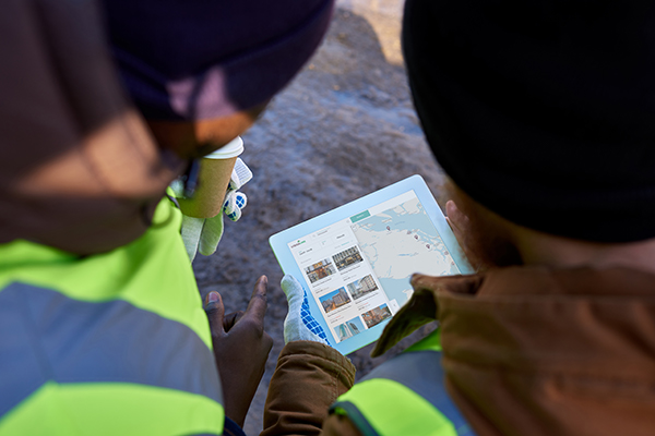 A close-up of a group of people looking at a map on a workforce travel site